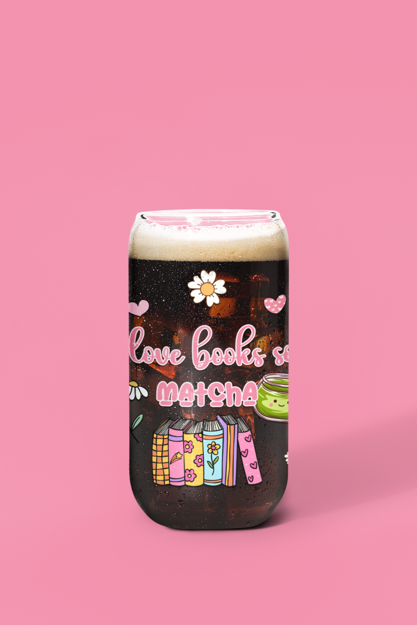 A glass can with a design that includes text 'I love books so matcha' and illustrations of books and a cup of matcha. bookish glassware for matcha lovers